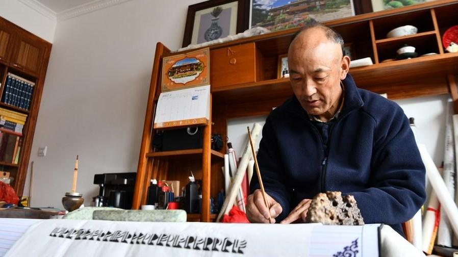 Tibetan craftsman repairs palm-leaf books to preserve old texts