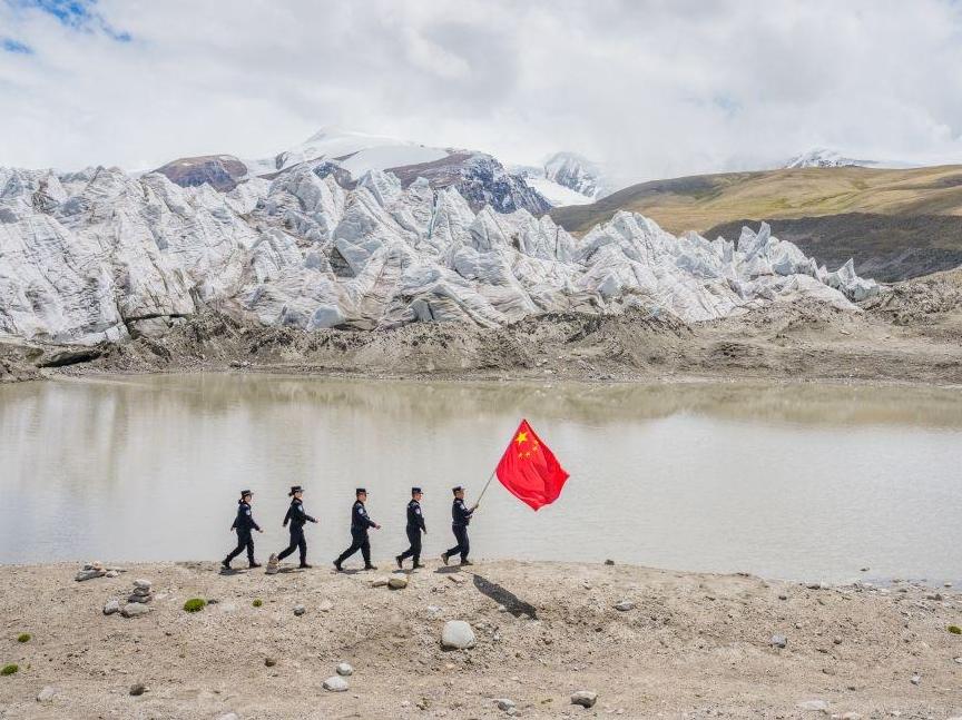 Police officers stand guard at China's highest-altitude border police station