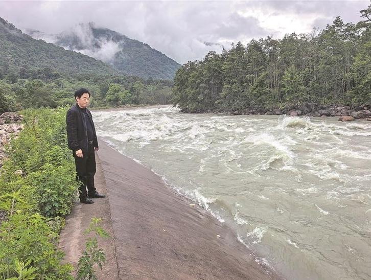 Guarding the clear waters of a river in Metok County